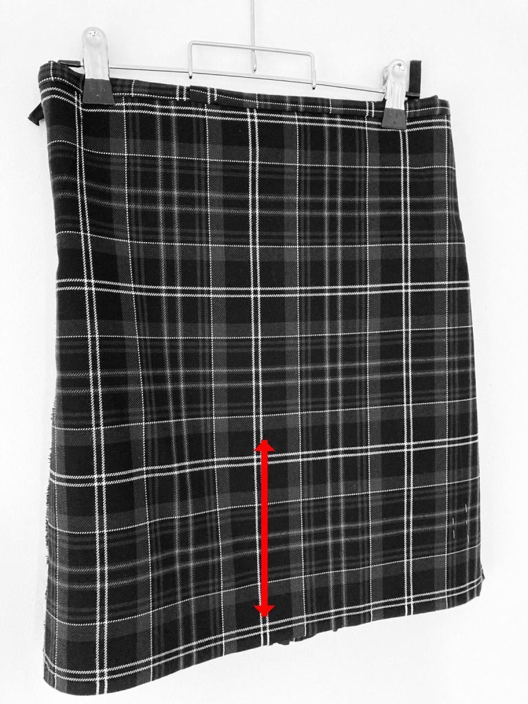 Kilt length adjustment showing shortened hem on grey tartan - Glasgow kilt alteration service 