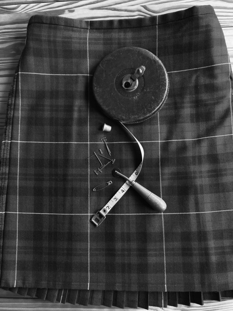 kilt restoration sewing tools laid out on tartan fabric