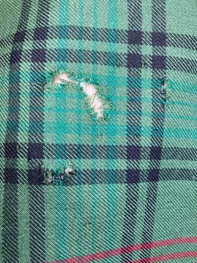 Invisible mending on a traditional Scottish kilt, professionally repaired in Glasgow.