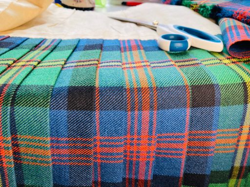 Open kilt on the table during major waist adjustment.